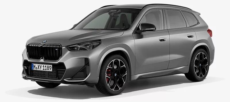 Gray BMW SUV parked on a white studio background, front-left angle showing bold black kidney grille and dark alloy wheels with red brake calipers