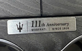 Metal Maserati plaque reading '111th Anniversary' with the trident logo and 'Since 1914'