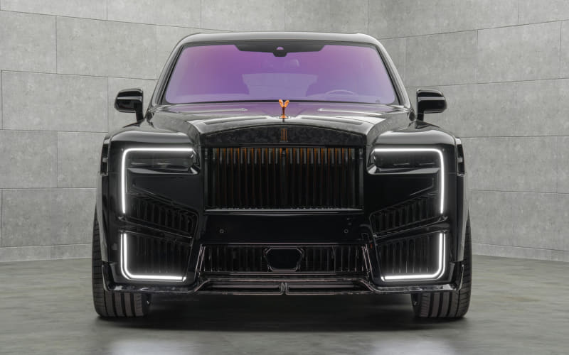 Front view of a black luxury SUV with a prominent vertical grille, sculpted bumper, and LED daytime running lights on the sides