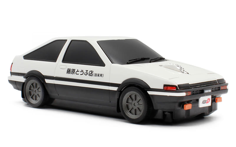 White toy car model with a black stripe and Japanese text on the side, resembling a scale model of a classic coupe.