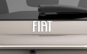 Beige Fiat car rear with the silver FIAT badge centered on the trunk.