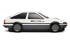 White two-door sedan with a black side stripe and Japanese text on the front door, isolated on white.