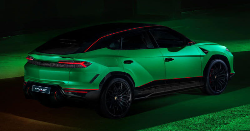 Bright green Lamborghini Urus SUV with a black roof and red accent lines, parked indoors under green lighting.