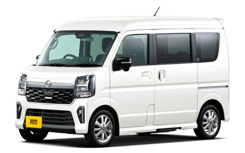 White compact passenger van with side sliding door and tinted windows on a white background.
