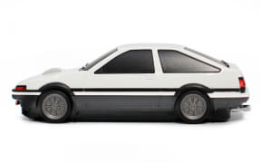 Side view of a white compact coupe with black trim and tinted windows.