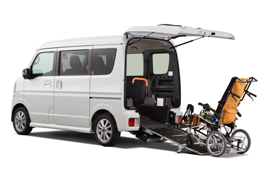 Wheelchair-accessible van with a ramp deployed and a wheelchair loaded into the rear area, ready for transport