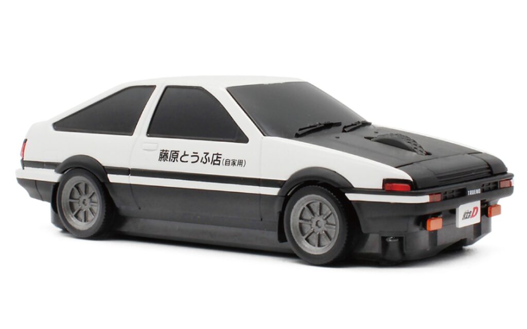 White and black die-cast toy car, seen from the front-left, with Japanese text on the door.