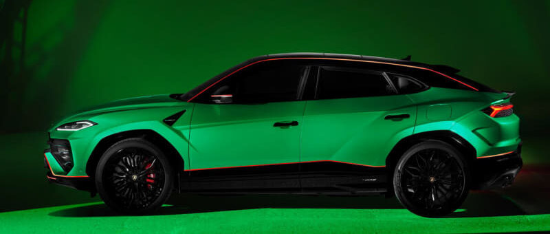 Green sports SUV in a studio with red accents and black wheels under green lighting, side profile view