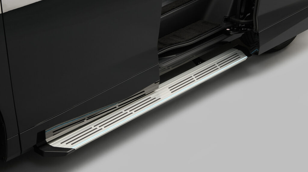 014_o - 自社ローン中古車販売専門店 ファンカーズ Open car door with a chrome running board along the side of a black vehicle, showing the step and door frame nearby.