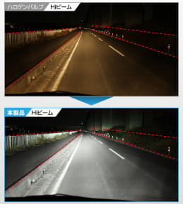 Nighttime highway scene with a dashed center line and red reflector barriers along the roadside guardrail and barriers.