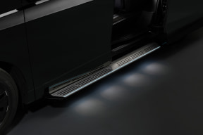 015_m - 自社ローン中古車販売専門店 ファンカーズ Open side door of a dark minivan with lit aluminum running boards and step lights.