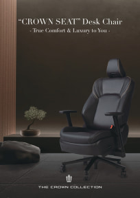 Lifestyle shot of a black executive desk chair in a dark, modern office setting; text reads 'CROWN SPAT Desk Chair' 'True Comfort & Luxury to You' and 'The Crown Collection'.