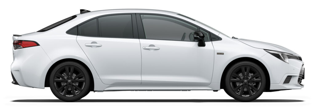 Side view of a white four-door sedan with dark windows and black alloy wheels, shown from the left.