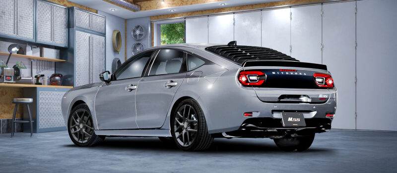 Grey sedan parked in a tidy home garage, with a workbench, pegboard and overhead track lighting on the ceiling.