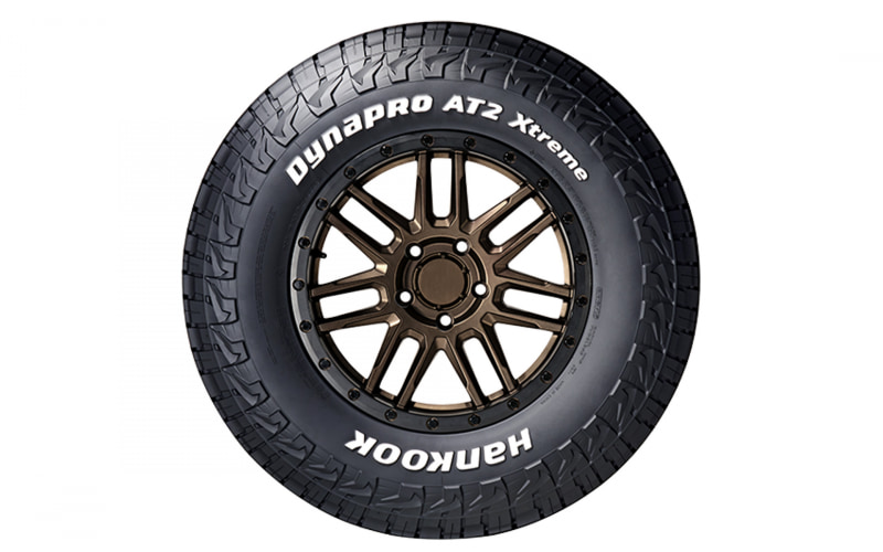 Dynapro AT2 Xtreme tire on bronze multi-spoke wheel, with white lettering reading 'DYNAPRO AT2 xtreme' and 'HANKOOK'.
