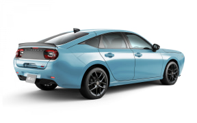 Blue sedan seen from a rear-side angle, showing taillights and dark alloy wheels