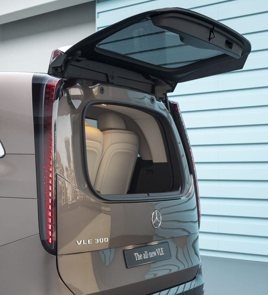 Rear view of a Mercedes-Benz VLE 300 with the tailgate open, exposing light beige leather seats inside.