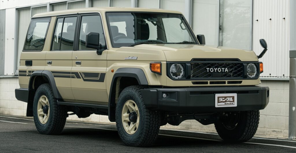 Beige Toyota Land Cruiser SUV parked outdoors in front of a modern building with large windows (side view).