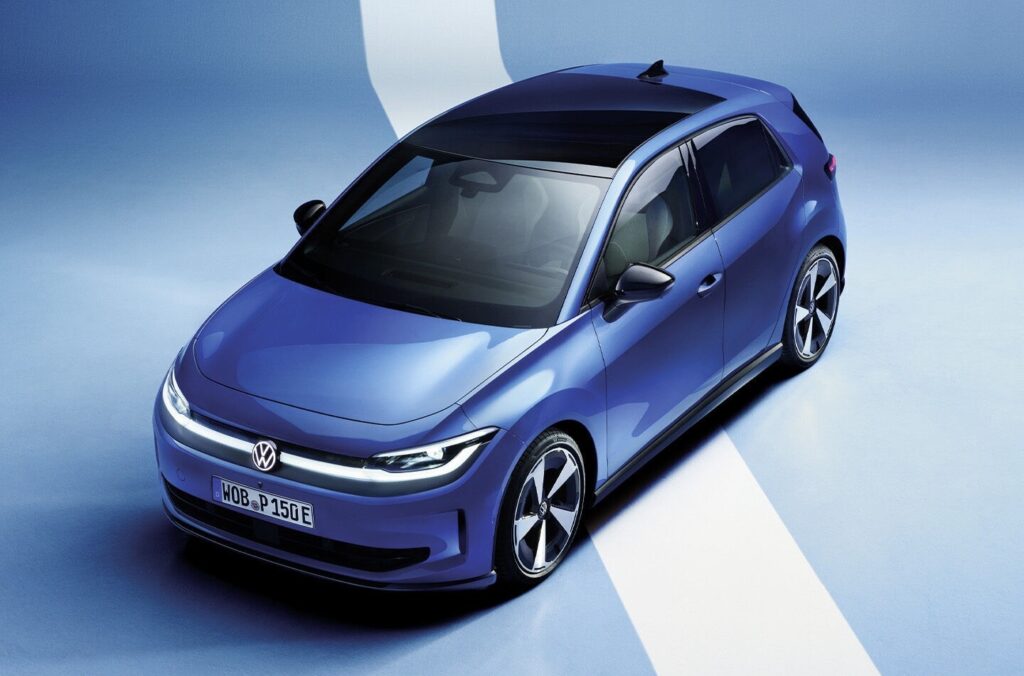 Blue Volkswagen hatchback seen from above on a pale blue studio backdrop with a white stripe influence in the background.