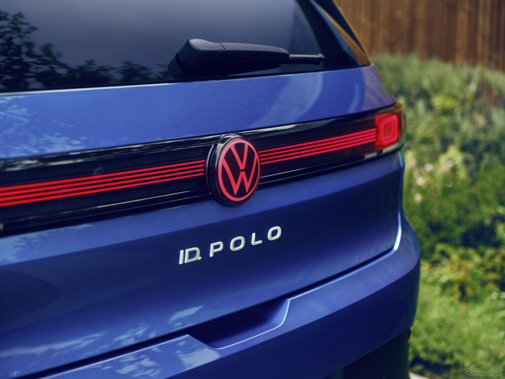 Rear view of a blue Volkswagen ID. Polo showing a red-accented grille stripe and VW emblem