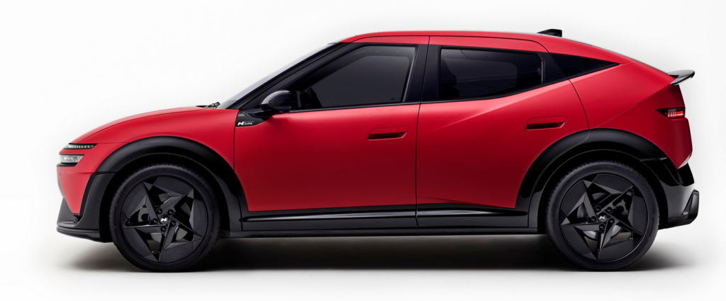 Profile view of a red compact SUV/crossover with black trim and large black wheels on a white background.