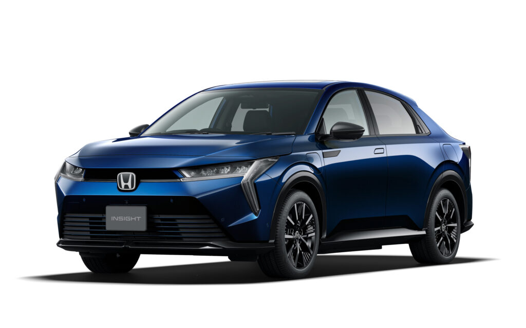 Blue Honda Insight sedan shown in a three-quarter front view, highlighting the car's sharp headlights and grille.